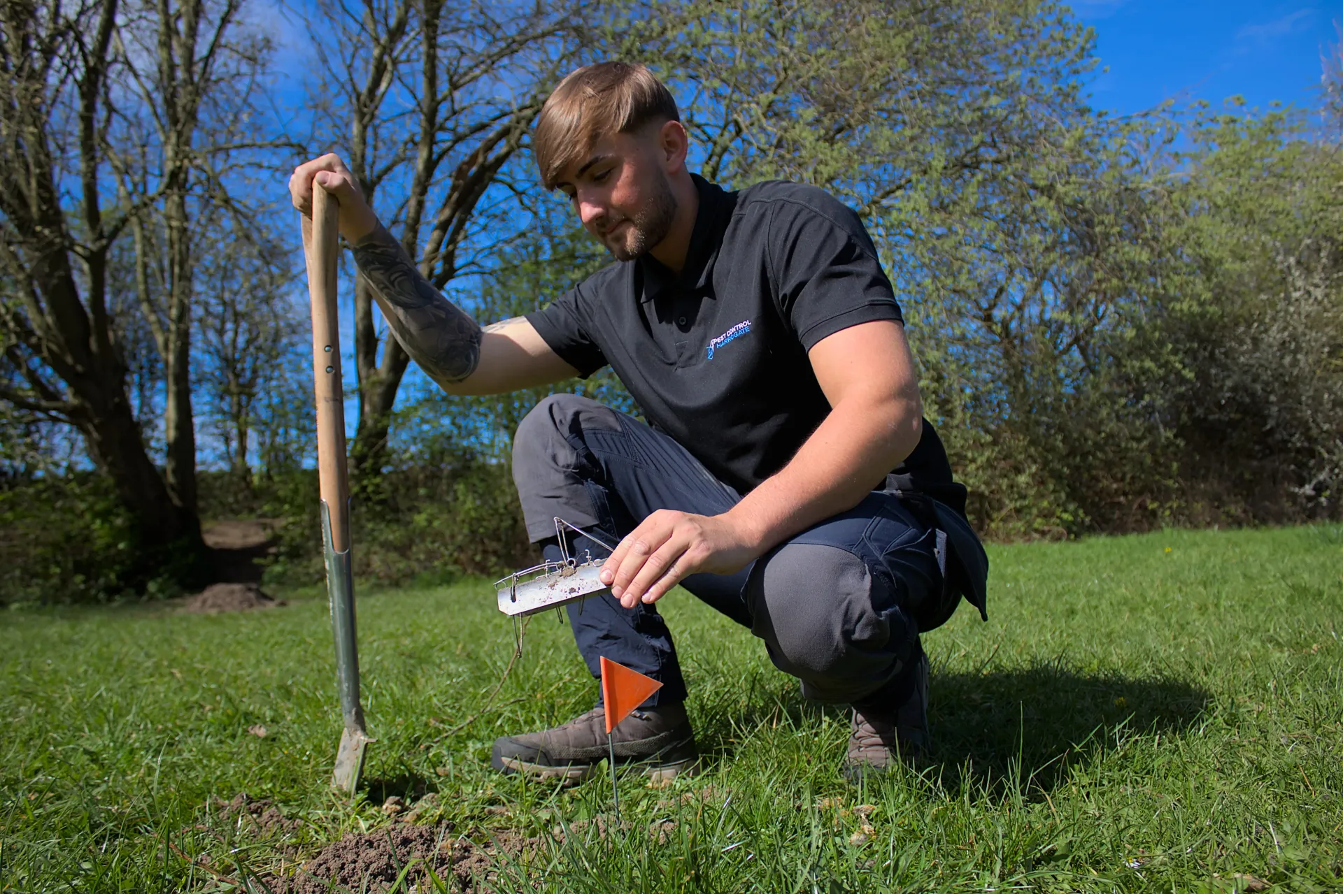 Professional mole control technician setting a trap in Harrogate to remove garden pests.
